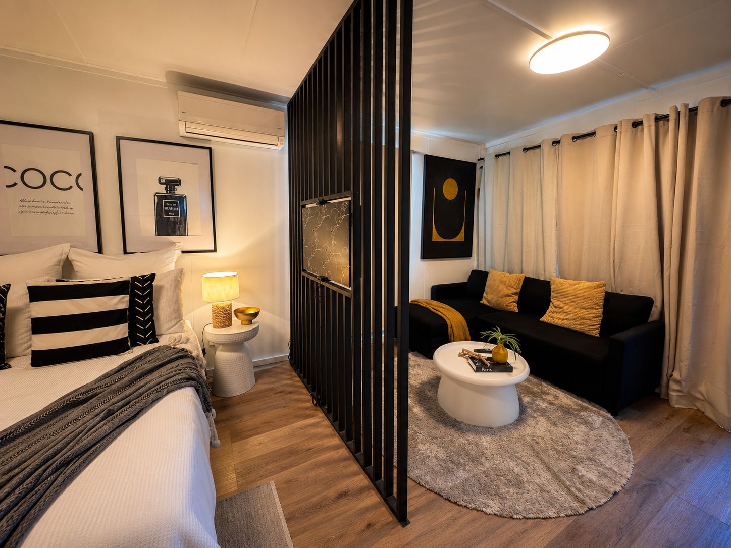 A modern, well-lit bedroom with a bed, bedside tables, and a nightstand.