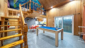 A wooden interior with a pool table, a staircase, and a kitchen area. - Gapyeong Haneuldari pet Pension (Gapyeong)