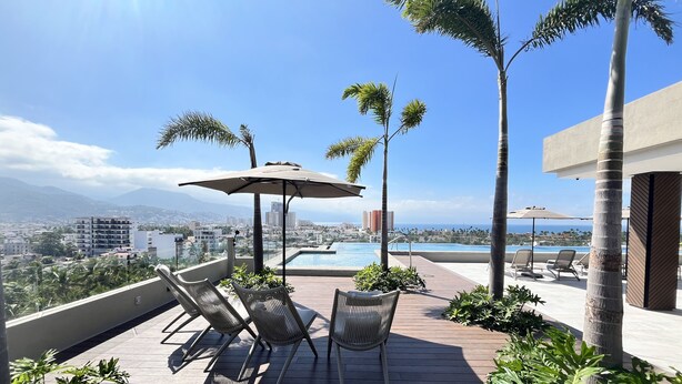 A rooftop terrace with a pool, lounge chairs, and palm trees. - Brand new Penthouse in Versalles & awesome Rooftop 2BD Penthouse for rent in Ver (Puerto Vallarta)
