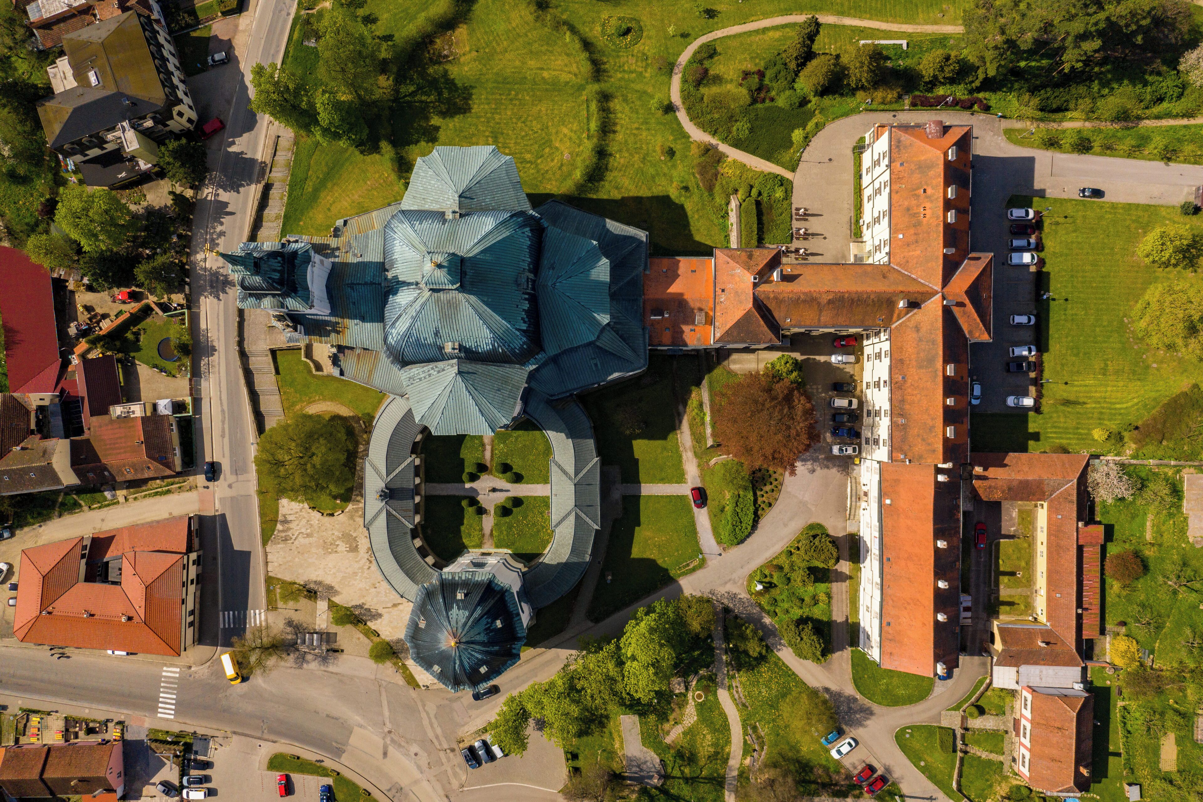 An aerial view of a church with a distinctive dome and adjacent buildings.