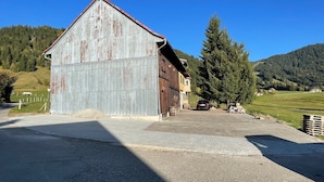 A rustic barn with a sloped roof, situated in a rural setting with a clear sky and a large evergreen tree nearby. - Ferienhof Wäldle 2 Balderschwang - Direkt an der Loipe mit Motorradvermietung (Balderschwang)