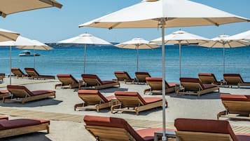 On the beach, sun loungers, beach umbrellas, beach towels