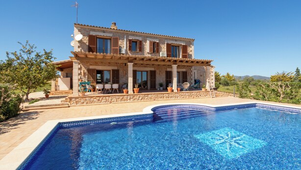 Une maison à deux étages avec une piscine à l’avant.