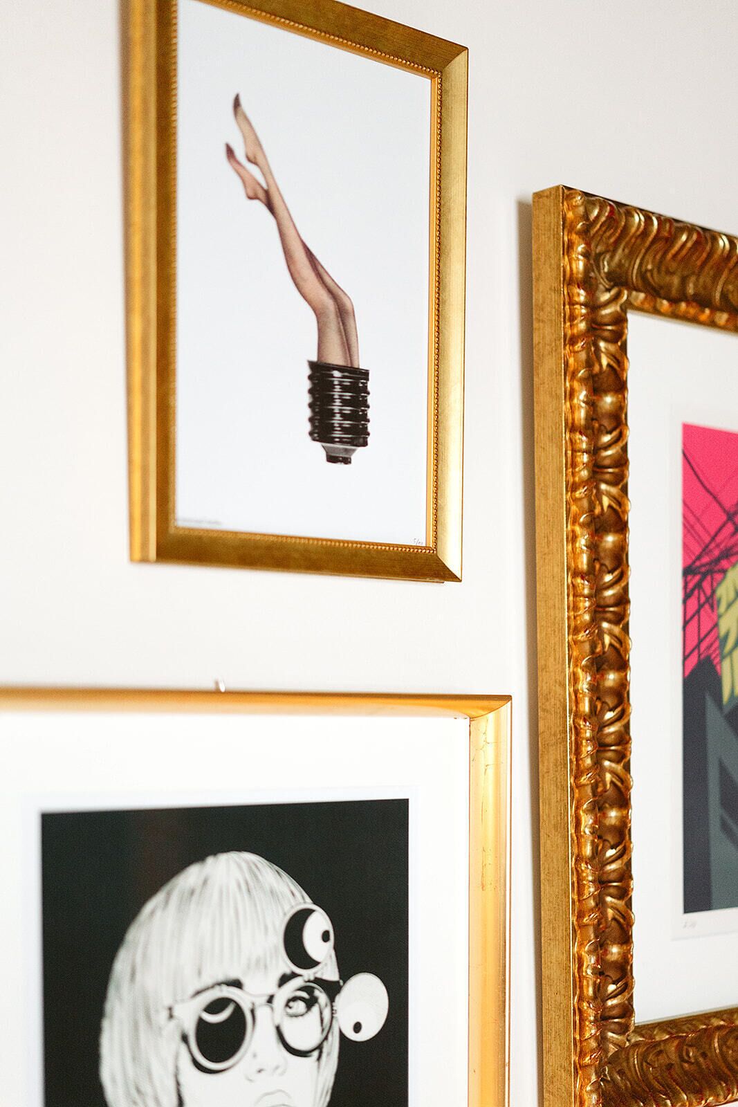 A wall with three framed artworks.