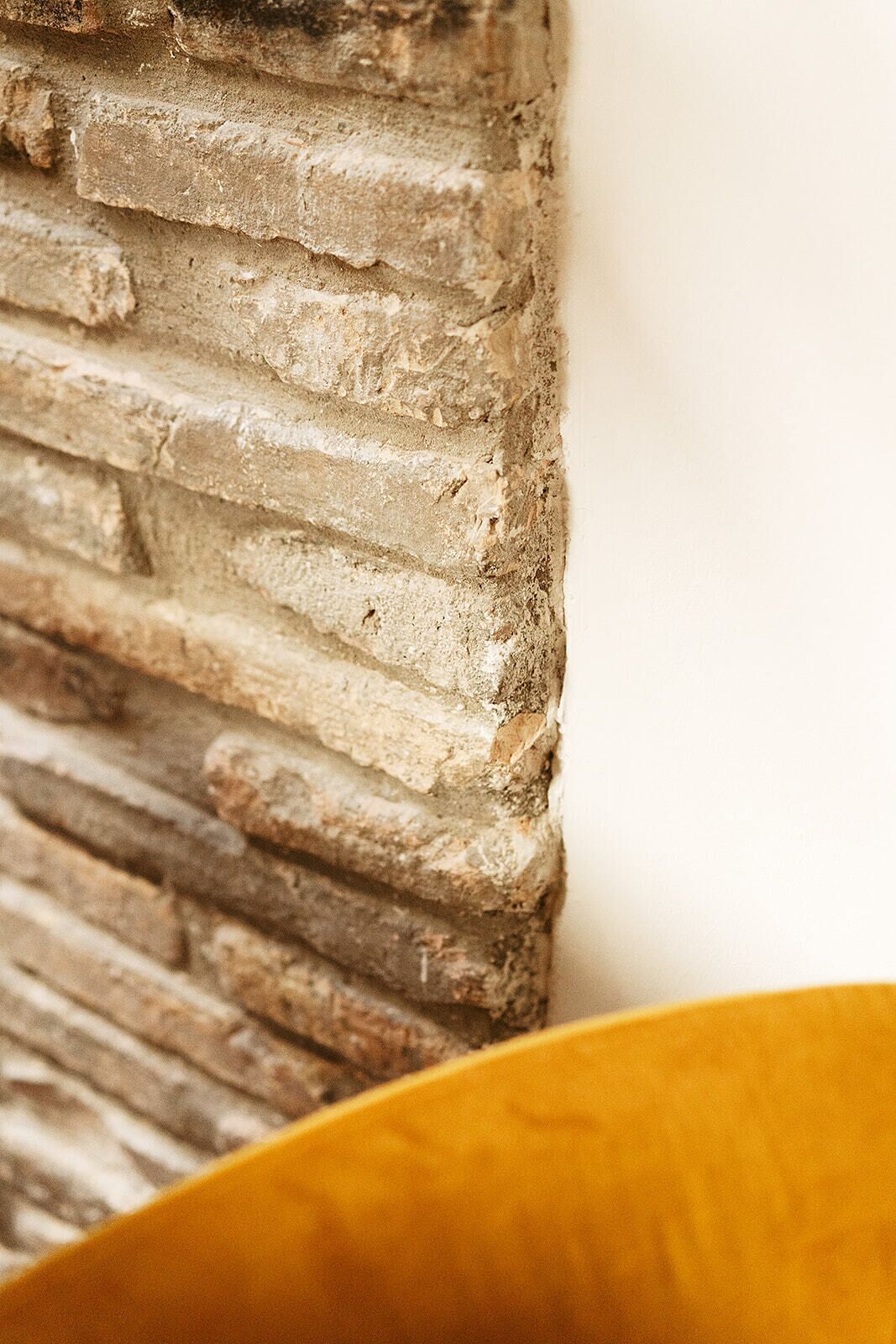 A close-up of a textured wall with a rough, uneven surface.
