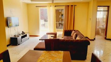 Deluxe Apartment | Living area | 24-inch Smart TV with digital channels