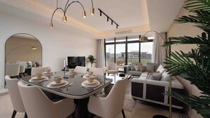 A modern living room with a dining area, large windows, and a view of the city. - BIRD NEST at Cairo Festival City (New Cairo)