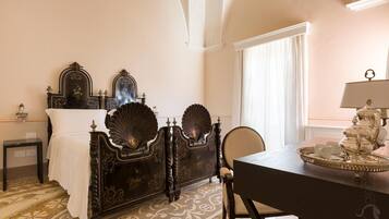 A room with a bed, a table with a tray, and a chair.