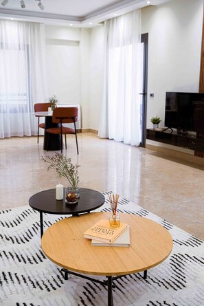 Studio | Living area | 43-inch LCD TV with satellite channels - BIRD NEST Near AUC (New Cairo)