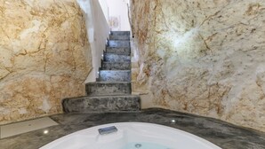 A spa area with a hot tub, marble walls, and a staircase. - 19 White Luxury Suite With Jacuzzi by Wonderful Italy (Ostuni)