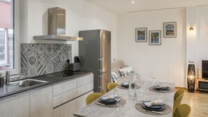 A modern kitchen with a stainless steel refrigerator, a built-in oven, and a patterned backsplash. - Fuori Le Mura - Balcony & A/C (Como)