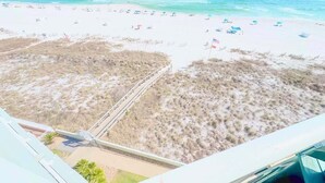 A beach with white sand and clear blue water. There are several umbrellas and beach chairs. - Silver Beach 602 |  Updated, Direct Beach Front, Pet Friendly! (Orange Beach)