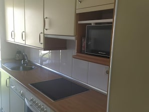 Een magnetron, een oven, een kookplaat, een koffiezetapparaat/waterkoker