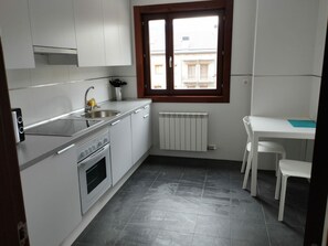 Enjoy meals in this kitchen with an oven, stainless steel sink, and ample counter space.