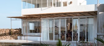 An architectural oasis with large swimming pool, along a breath-taking scenery.