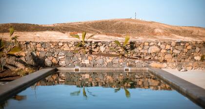 An architectural oasis with large swimming pool, along a breath-taking scenery.