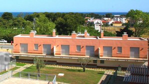 A two-story building with a swimming pool in the foreground. - Semi-detached houses in Creixell with pool, WiFi, parking, and air conditioning (Creixell)