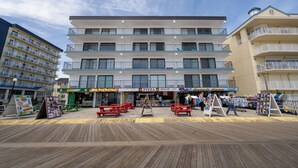A multi-story building with a ground-level restaurant and a visible Subway. - Located on the boardwalk and has an indoor pool, great vacation rental! (Ocean City)