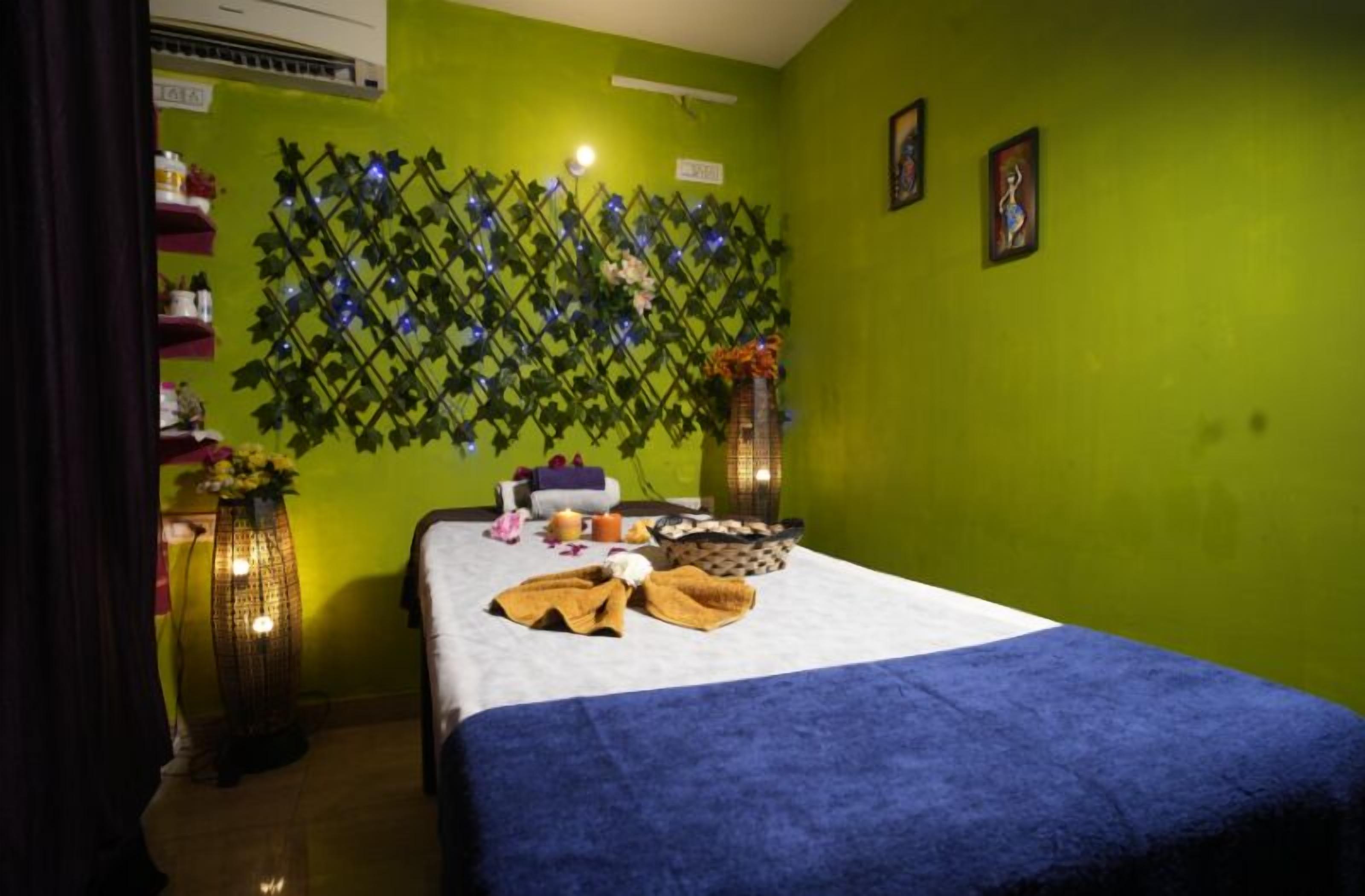 A room with a bed, a decorative wall, and a small table with items.