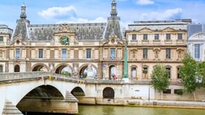 A historic building with a bridge over a river, featuring classical architecture and a clock tower. - 178 Suite Cesar - Superb apartment in Paris (Paris 11 Popincourt)