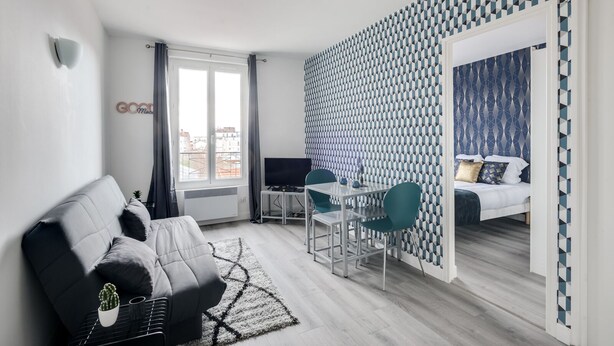A modern apartment with a living area, a dining space, and a bedroom.
