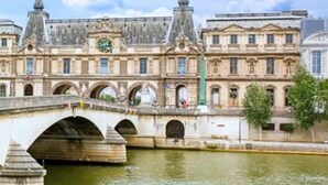 A historic building with a bridge over a river, featuring classical architecture and a clock tower. - 294 Suite Naza - Superb apartment in Paris (Paris 03 Temple)