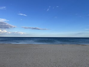 A beach with a clear sky and calm sea.