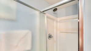 A glass shower enclosure with a showerhead and a door handle. - Coastal Condo w/ Balcony in North Myrtle Beach! (North Myrtle Beach)