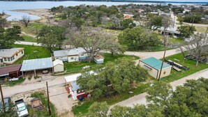 A residential area with houses, a small body of water, and a dock. - Pet-friendly Brownwood Home: Walk to Lake! (Brownwood)