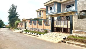 A row of modern two-story houses with a gated entrance and a paved driveway. - Anastera Home Vila (Kigali)