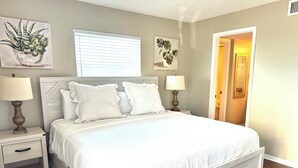 A neatly made bed with white bedding, two bedside tables with lamps, and artwork on the walls. - Surf Side Shores 1206  New Sofa   3 bd / 3 bth gulf-front corner unit (Gulf Shores)