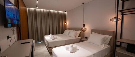 A modern hotel room with two beds, a desk, a TV, and a large window with curtains.