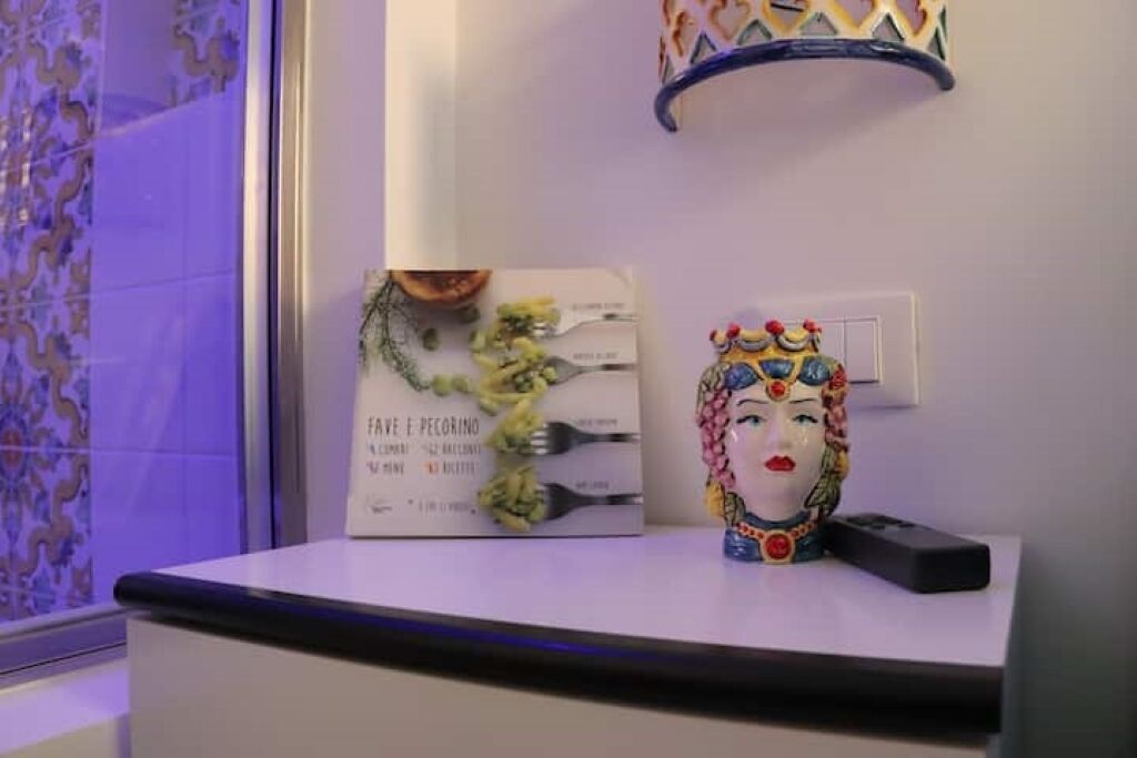 A reception desk with a menu, a decorative item, and a remote control.