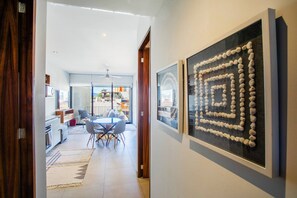 A modern interior with a dining area, a kitchen, and a living space.