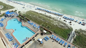 A resort with a swimming pool, beach area, and lounge chairs. - HUGE Corner Unit Free Beach Chairs! Free round of Golf & Activities Daily! (Panama City Beach)