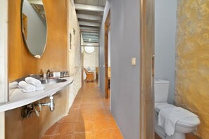 A narrow hallway with a bathroom on the right, featuring a toilet and a sink with towels. - Villa Mediterranea – Beachside Escape for Slow Living with Private Heated Pool (Livadia)