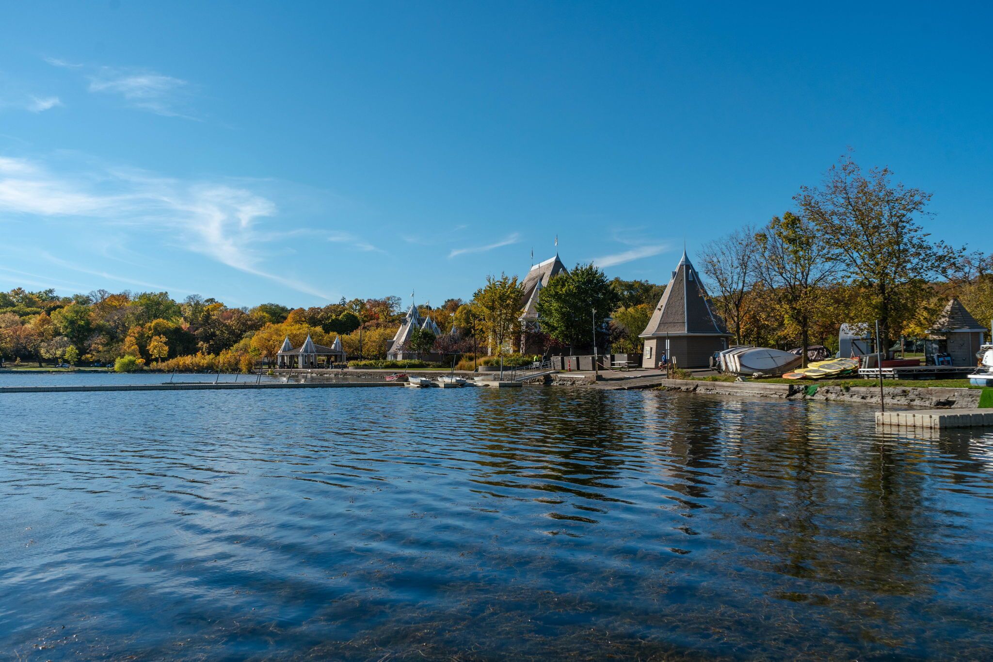 A lakeside view with buildings and trees.