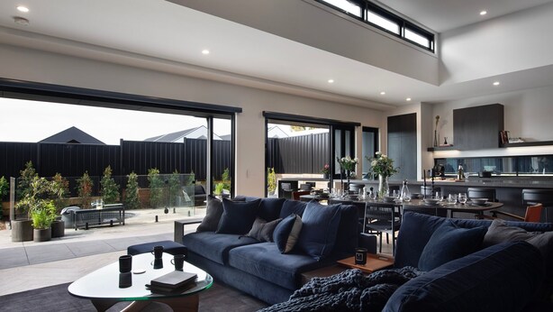 A modern living room with a sofa, coffee table, and dining area. - Chalet Noir- sleek design with heated plunge pool, close to town (Daylesford)
