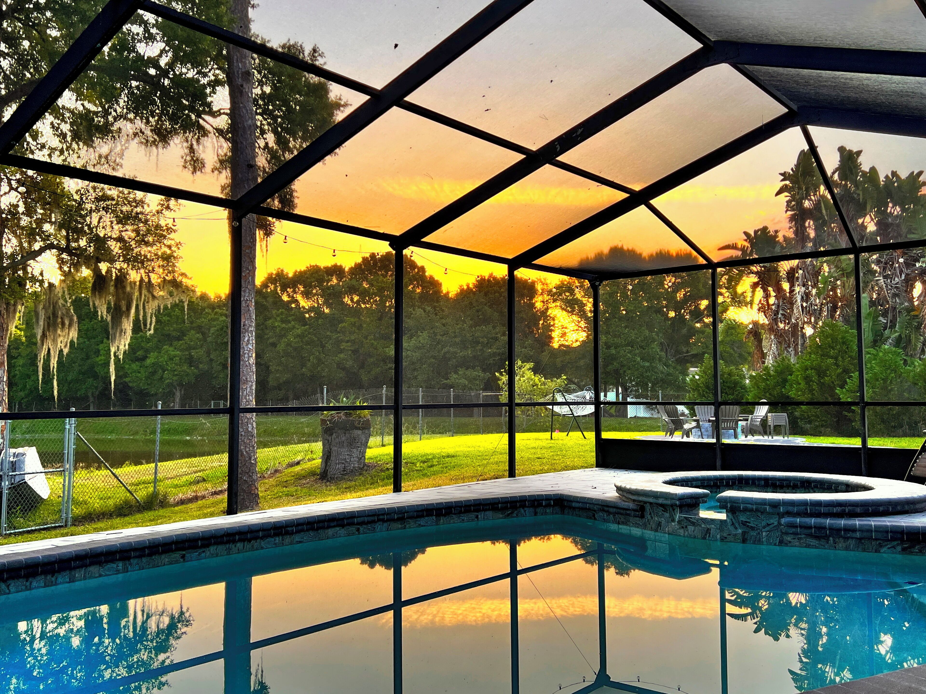 Golden hour turns the lanai into a living painting as the sky glows.