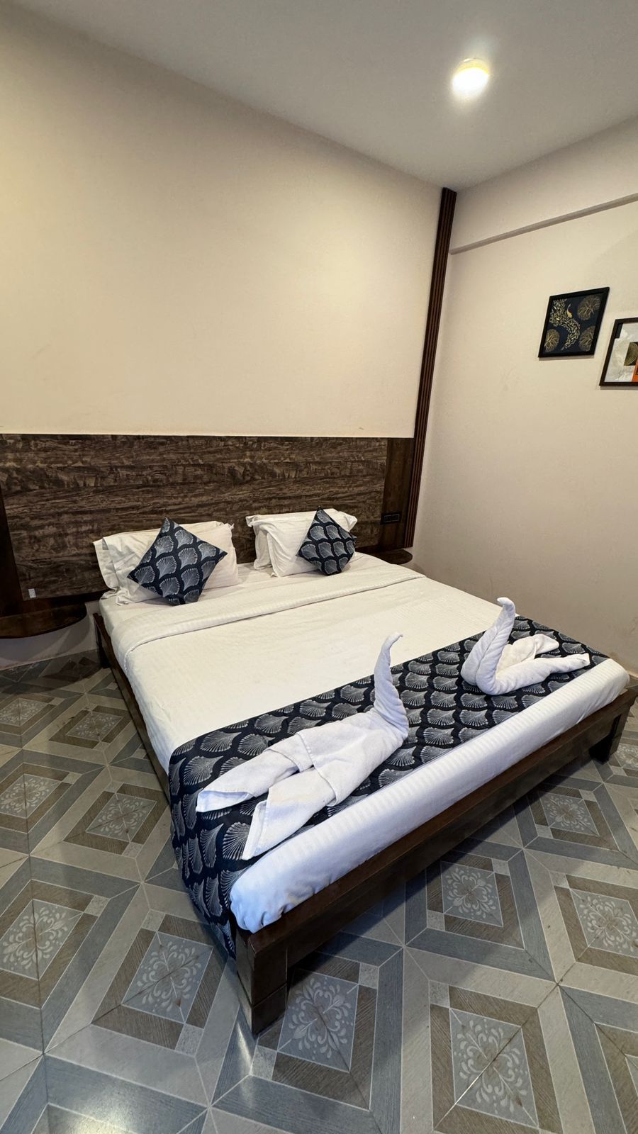 Une chambre d’hôtel avec un lit, des oreillers et des serviettes.