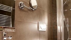 A modern bathroom with a large white sink, a mirror, a shower enclosure, and a toilet. - Basilio Veneto Rome (Rome)