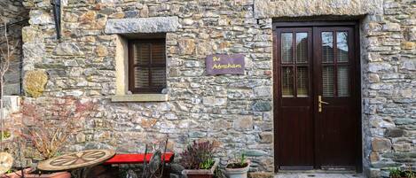 A stone building with a sign reading "The Abraham."