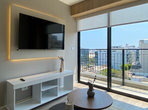 Apartment (905A) | Living area | 40-inch TV with cable channels - Los Pinos by Wynwood House (Lima)