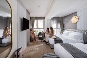 A hotel room with a bed, a sofa, a TV, a mirror, and a window with curtains. - Allenbeach TLV- Apt Hotel-Adults only (Tel Aviv)