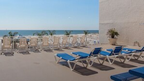 A rooftop terrace with sun loungers and a view of the beach. - Sept 12-17 DISCOUNT! Updated Right on the beach! Umbrella,2chairs,2beach towels! (Orange Beach)