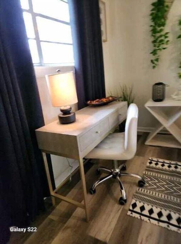 A modern office desk with a lamp, a white chair, and a patterned rug. - Comfy and cozy on Holly (Pooler)