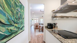A modern kitchen with a coffee maker, a toaster, and a countertop.