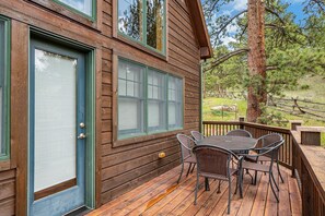 Enjoy a peaceful retreat with a deck and comfortable seating for four.