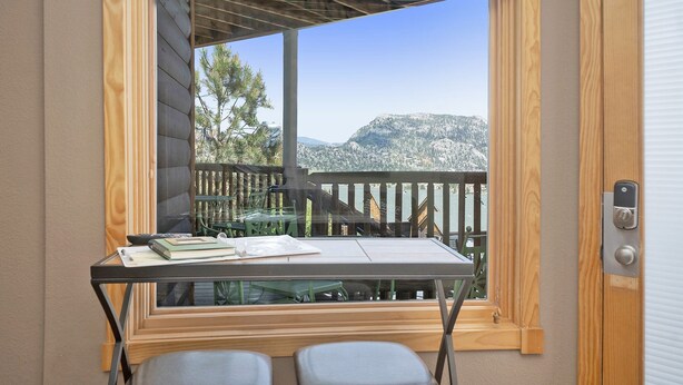 A room with a view of a wooden deck and mountains. - Horsetooth Peak 26C - 1 Br Condo - Lake and Mountain Views (Estes Park)