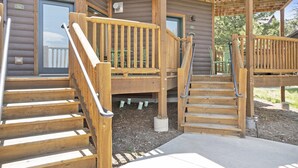 A wooden staircase leading to a covered outdoor area with a wooden deck and a door marked "26C". - Horsetooth Peak 26C - 1 Br Condo - Lake and Mountain Views (Estes Park)